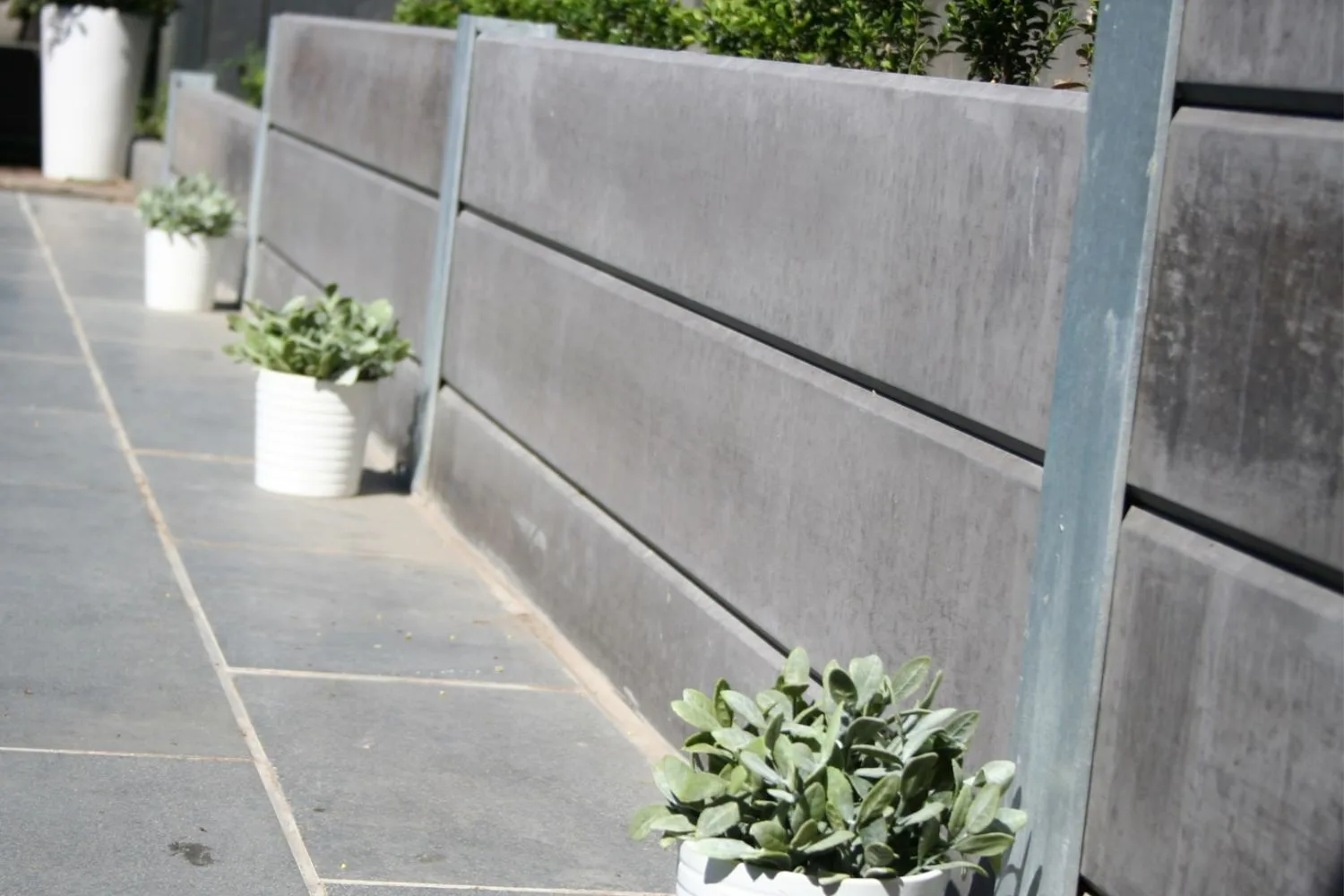 Concrete sleeper retaining wall detail with planter pots