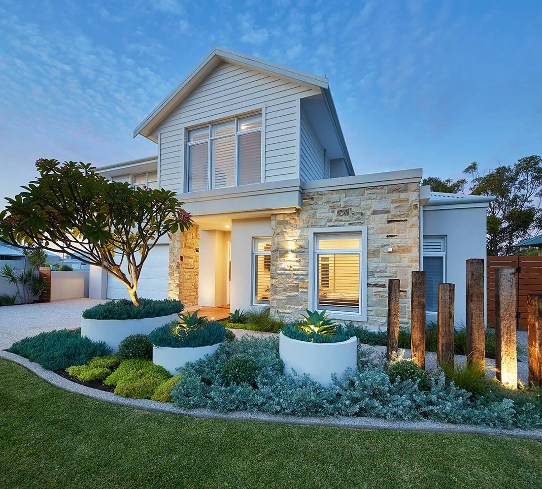 Timber sleeper retaining wall and garden bed beside a driveway