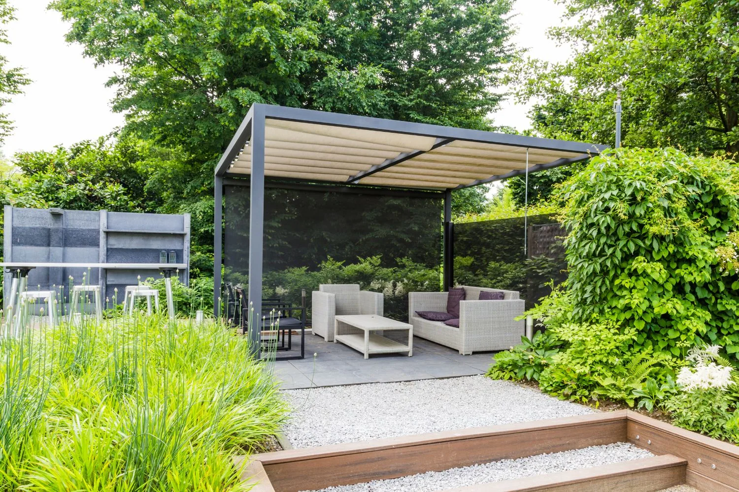 Modern pergola with retractable canopy over an outdoor lounge