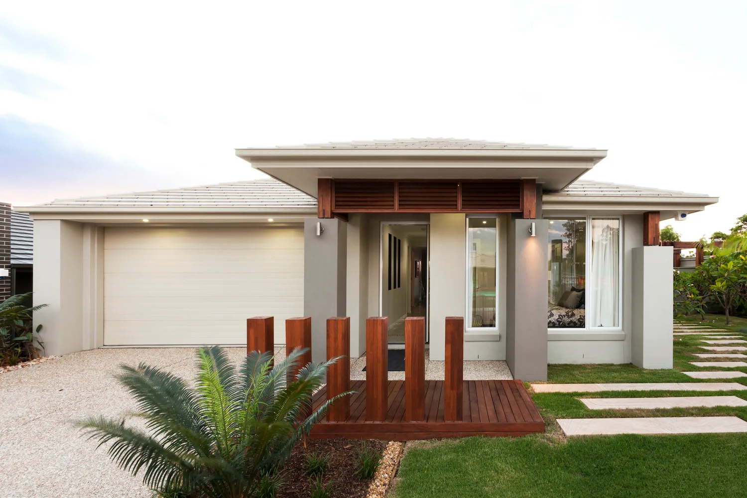 Modern home entrance with timber deck and feature landscaping