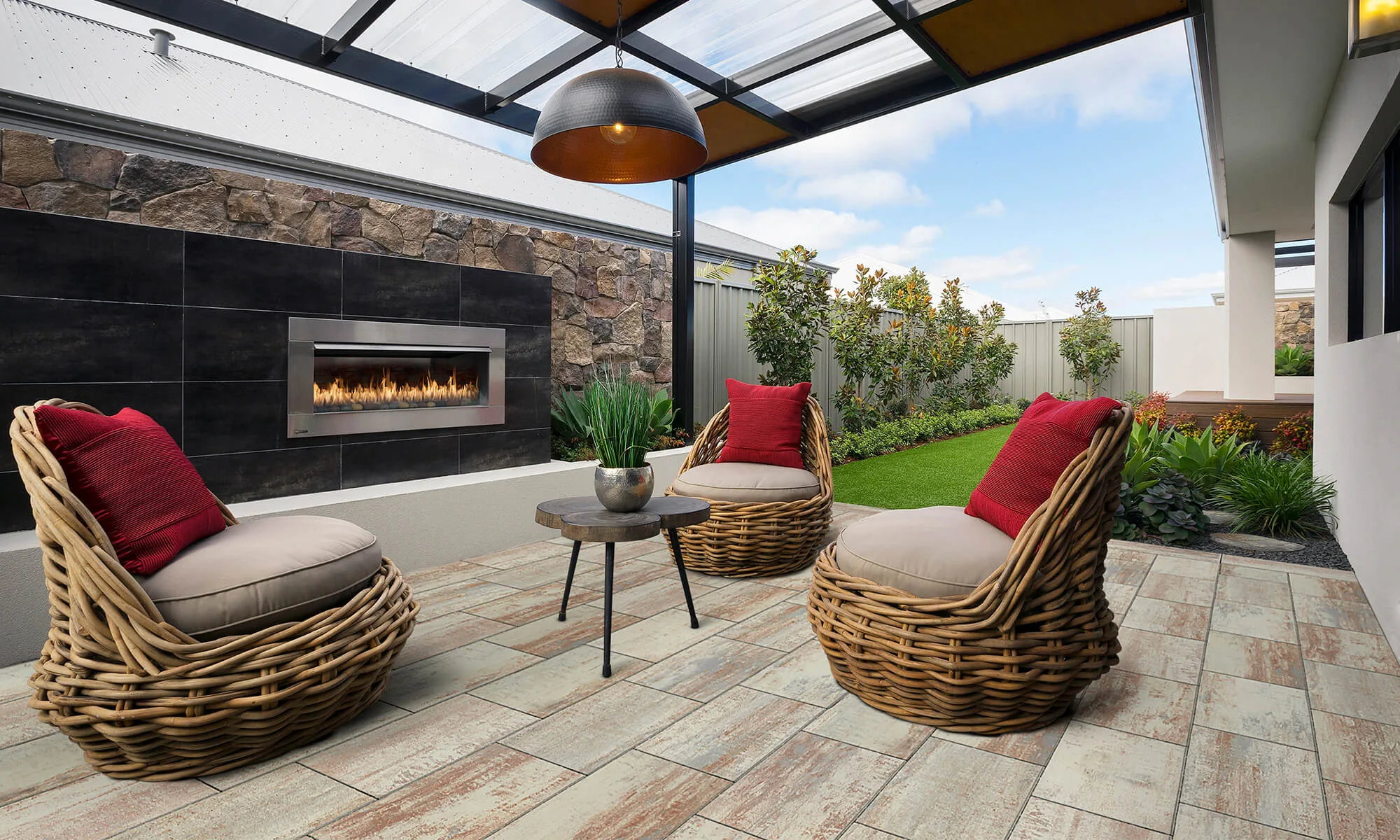 Outdoor lounge with stone feature wall and gas fireplace under a pergola